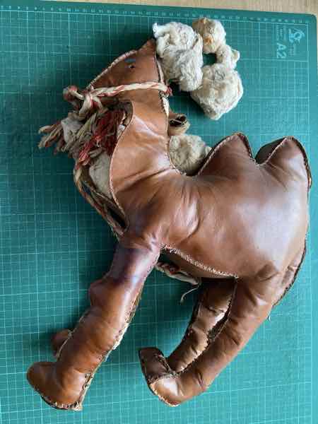An old leather camel dating from WW2 that requires re-stitching to keep the stuffing in